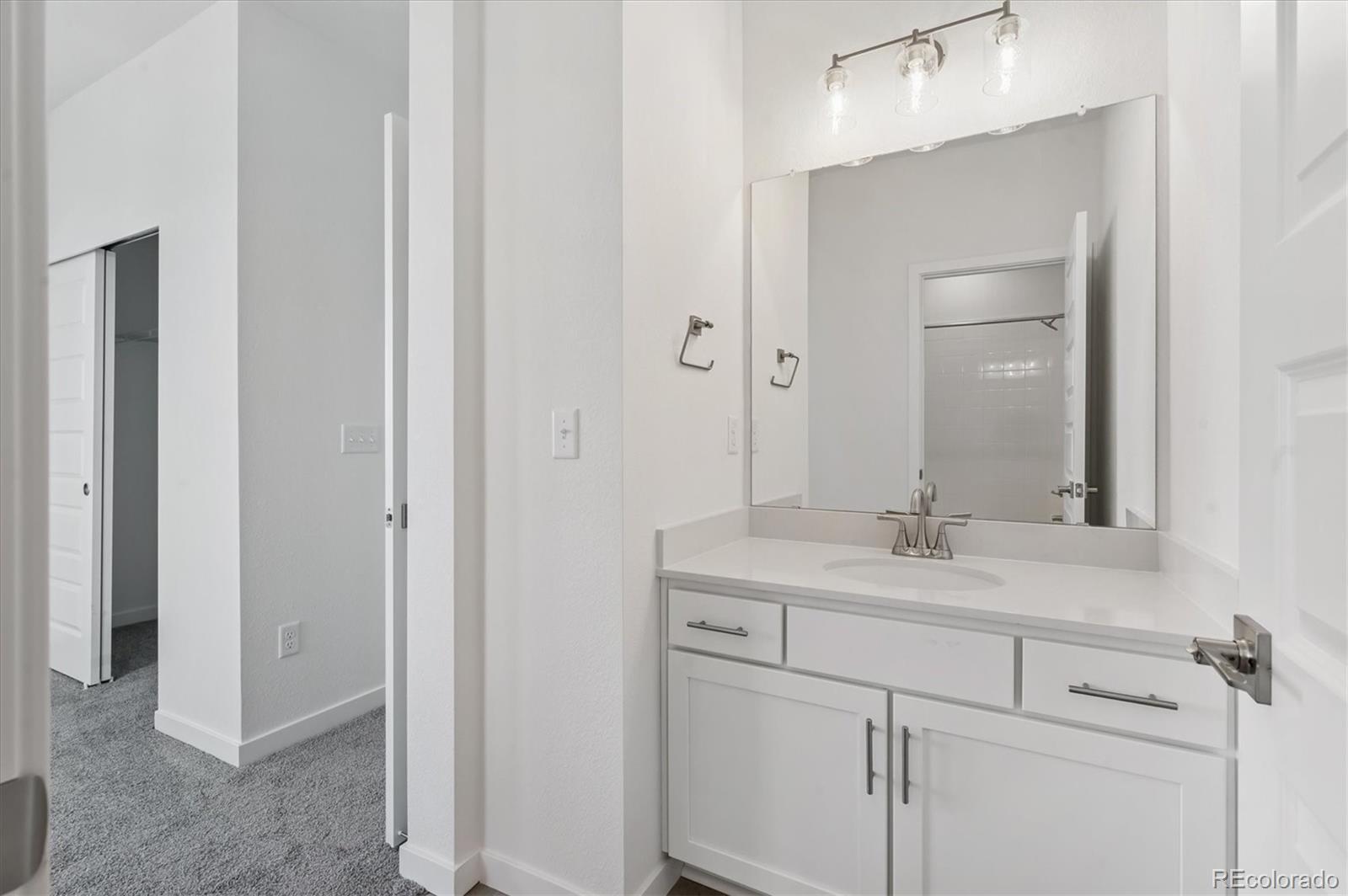 9123 White Ridge Road Englewood, CO 80112 - Photo 18 of 28 a bathroom with a sink and a mirror