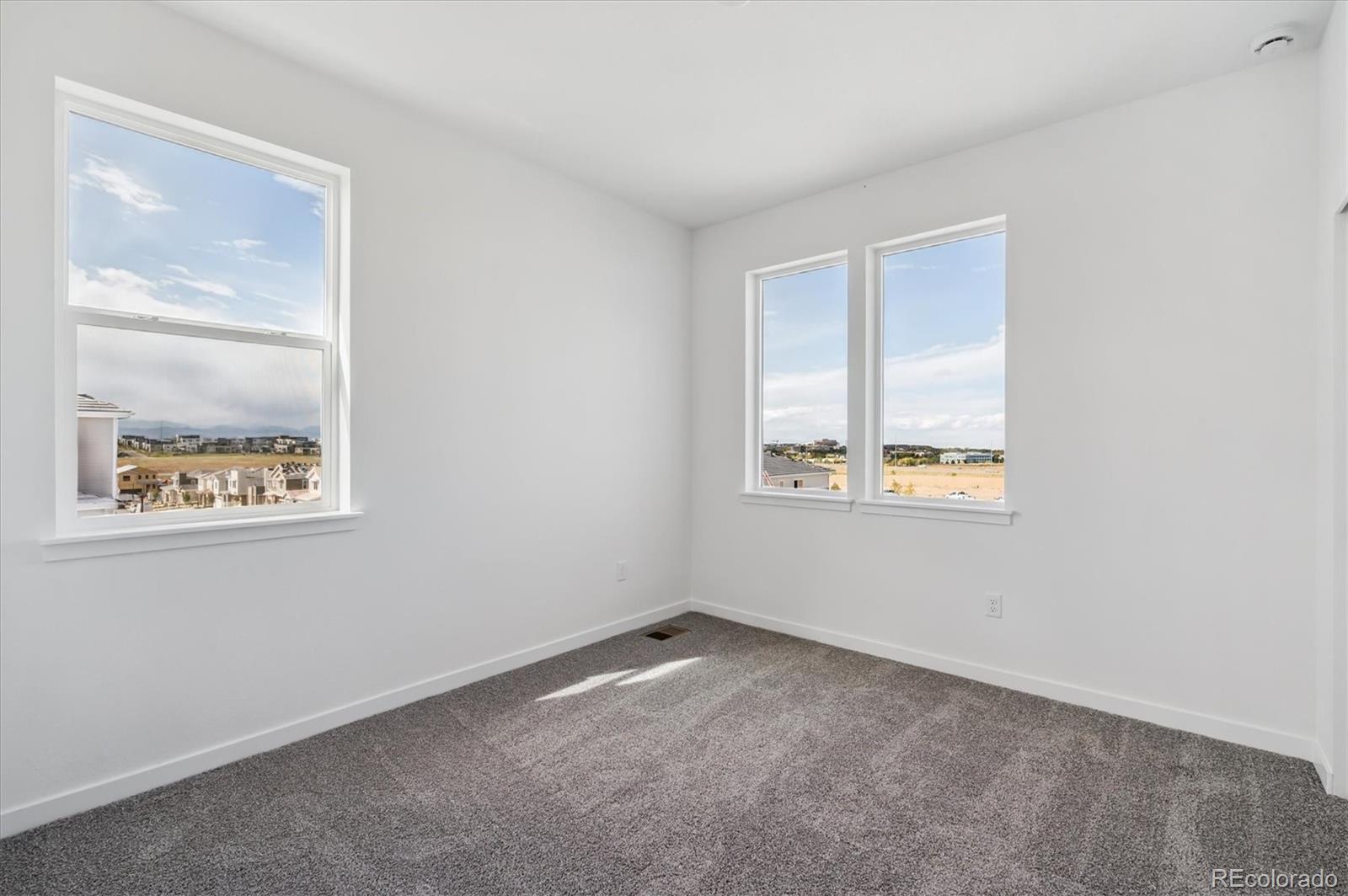 9123 White Ridge Road Englewood, CO 80112 - Photo 19 of 28 an empty room with windows