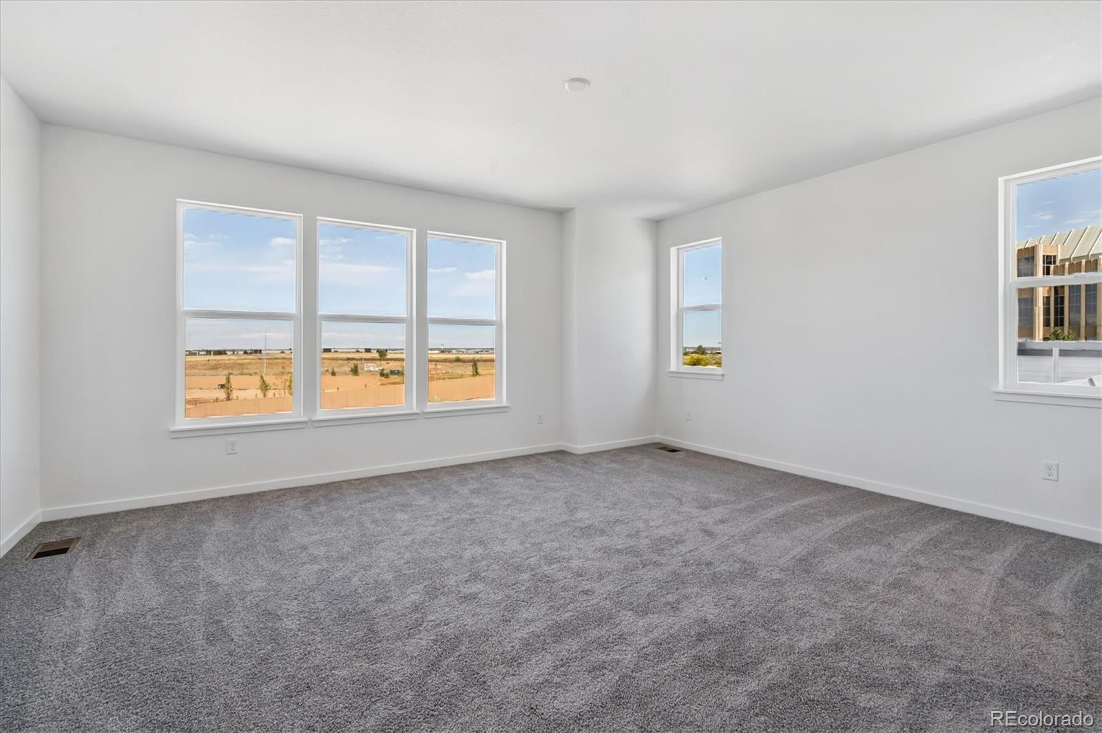 9123 White Ridge Road Englewood, CO 80112 - Photo 20 of 28 an empty room with windows