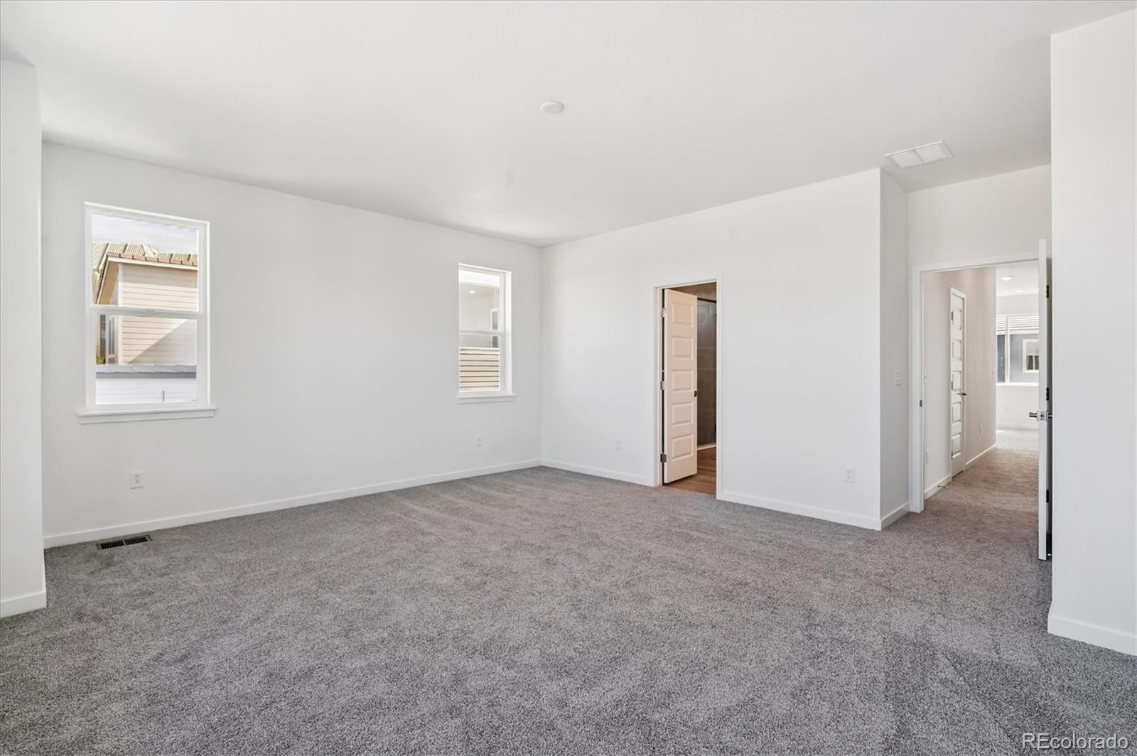 9123 White Ridge Road Englewood, CO 80112 - Photo 21 of 28 an empty room with windows and closet