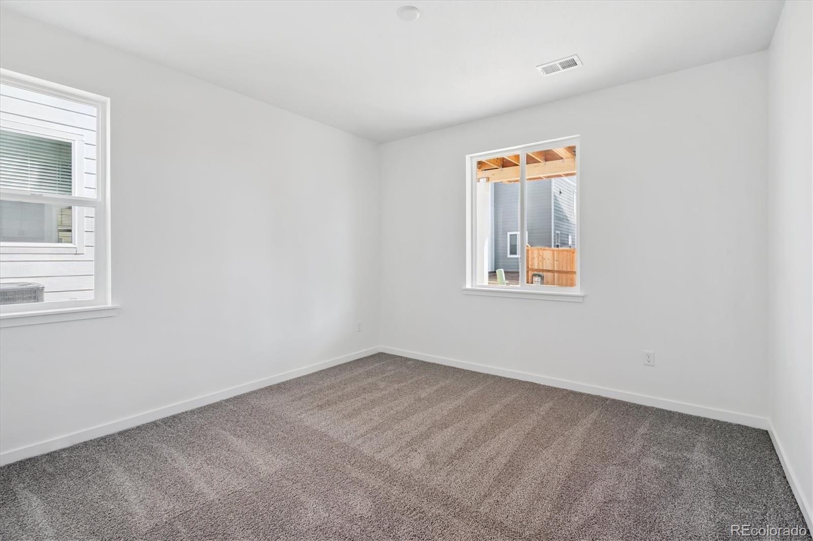 9123 White Ridge Road Englewood, CO 80112 - Photo 4 of 28 an empty room with windows