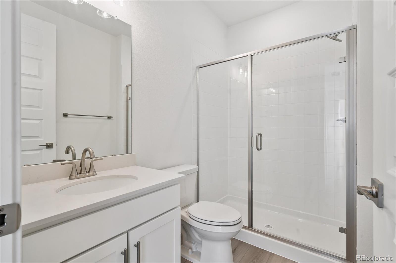 9123 White Ridge Road Englewood, CO 80112 - Photo 5 of 28 a bathroom with a sink toilet and shower