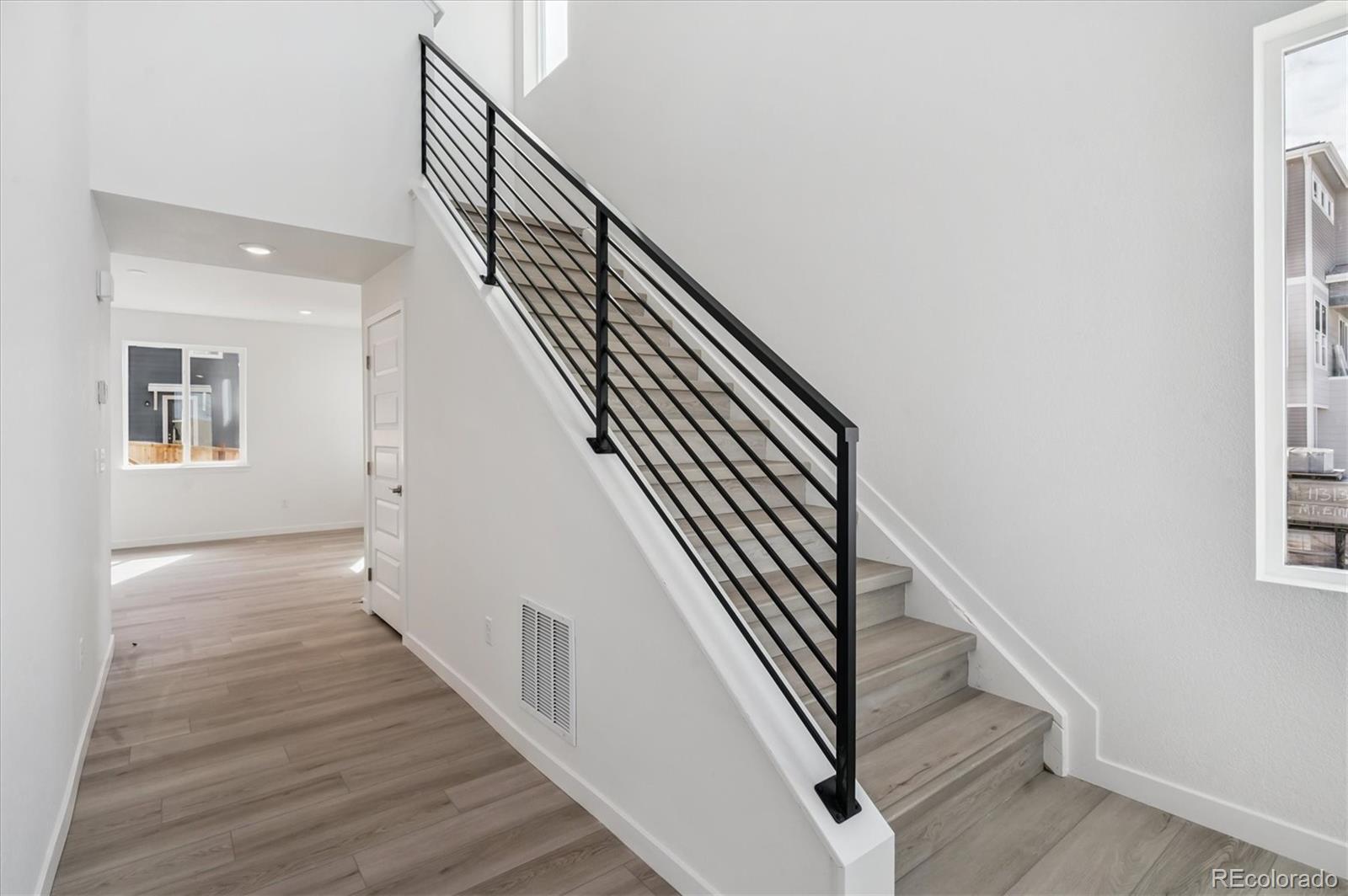 9123 White Ridge Road Englewood, CO 80112 - Photo 6 of 28 a view of entryway and hall with wooden floor