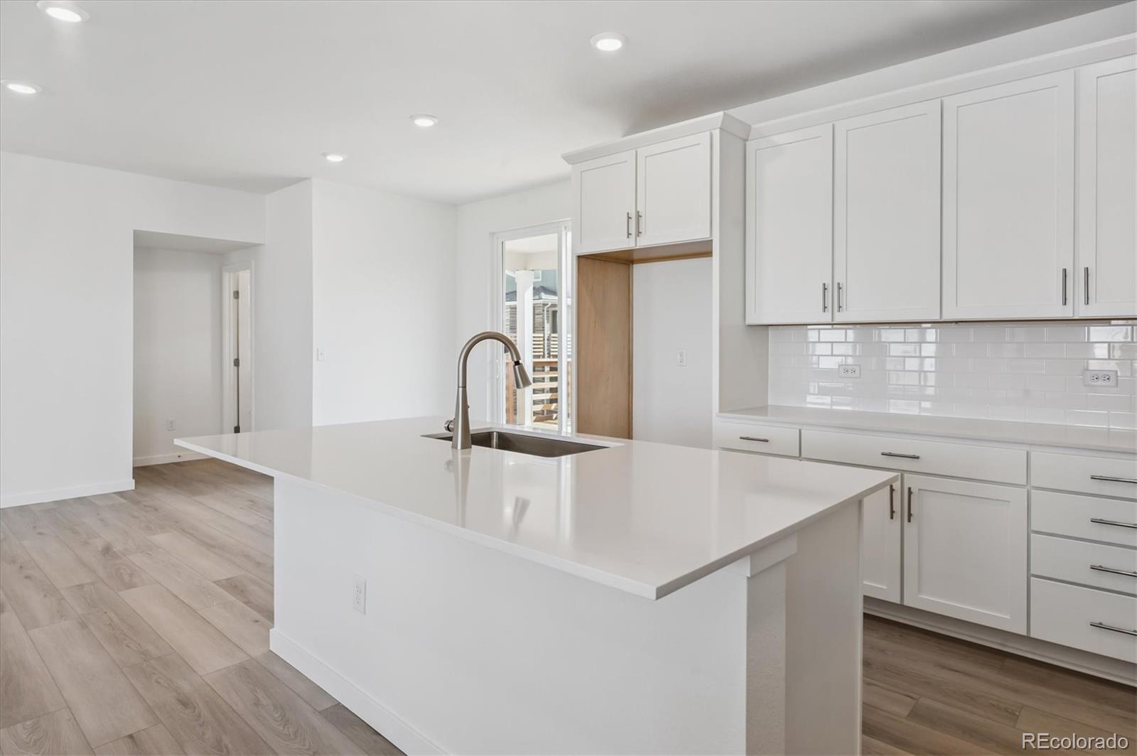 9123 White Ridge Road Englewood, CO 80112 - Photo 9 of 28 a kitchen with a sink a stove and cabinets