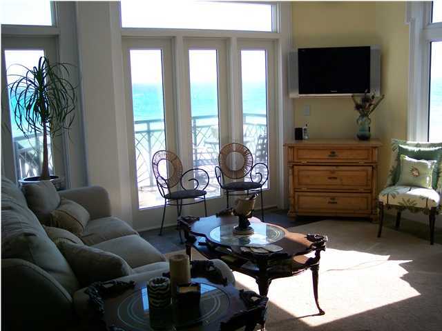 260 Wall Street Inlet Beach, FL 32461 - Photo 2 of 18 a living room with furniture a flat screen tv and a floor to ceiling window