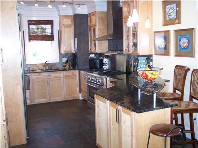 260 Wall Street Inlet Beach, FL 32461 - Photo 10 of 18 a kitchen with stainless steel appliances granite countertop a stove a sink and a microwave