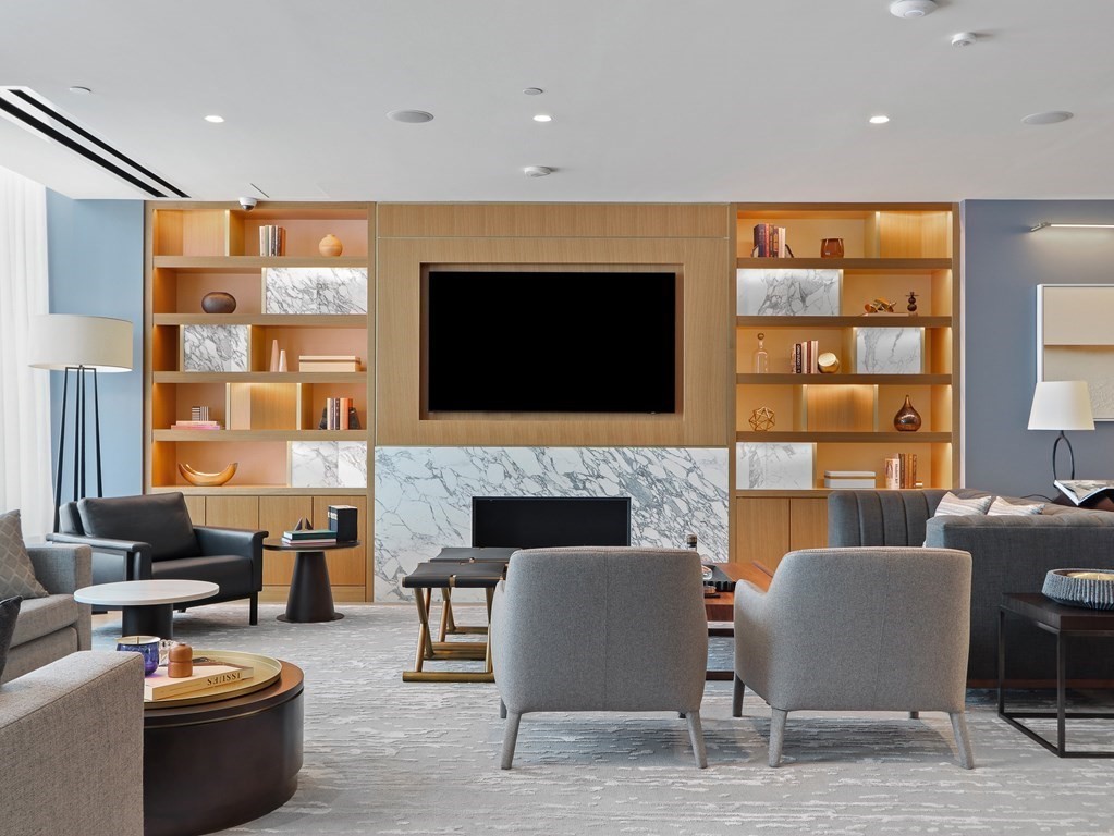 380 Harrison Avenue, Unit 14E Boston, MA 02118 - Photo 21 of 29 a living room with furniture a flat screen tv and a fireplace