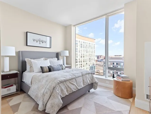 a bedroom with a large bed couch and a window