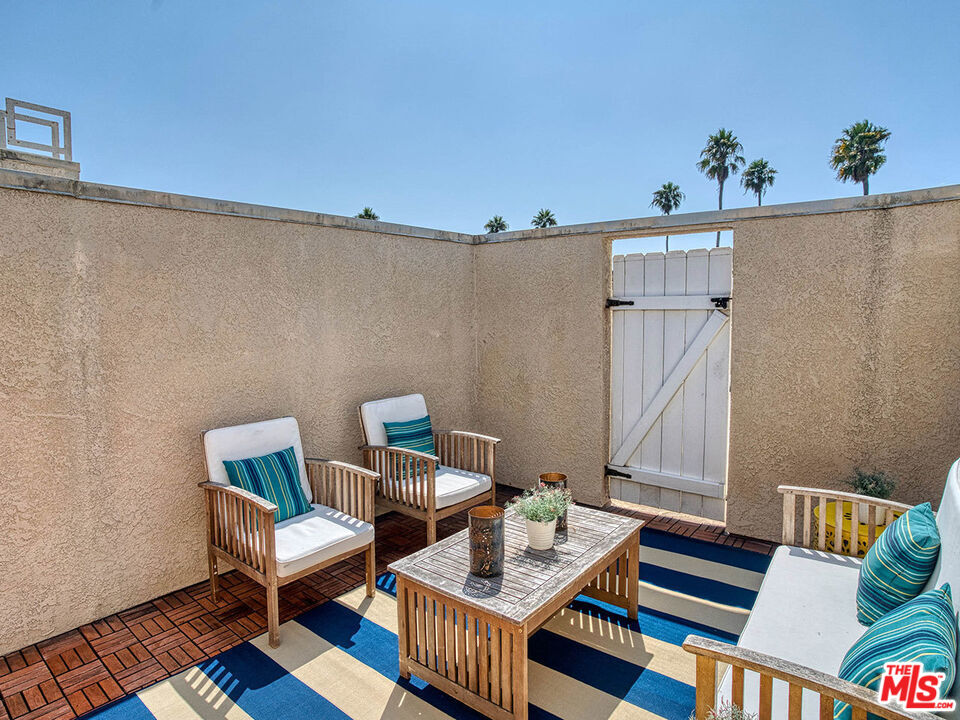 1133 9th Street, Unit 304 Santa Monica, CA 90403 - Photo 20 of 25 a living room with furniture and wooden floor