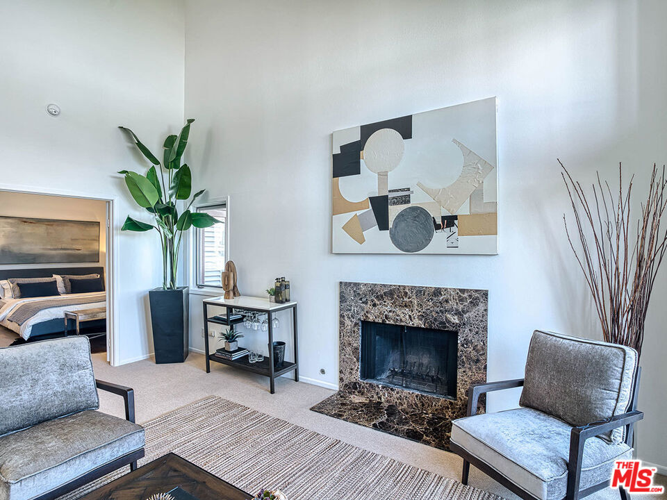 1133 9th Street, Unit 304 Santa Monica, CA 90403 - Photo 2 of 25 a living room with furniture and a fireplace