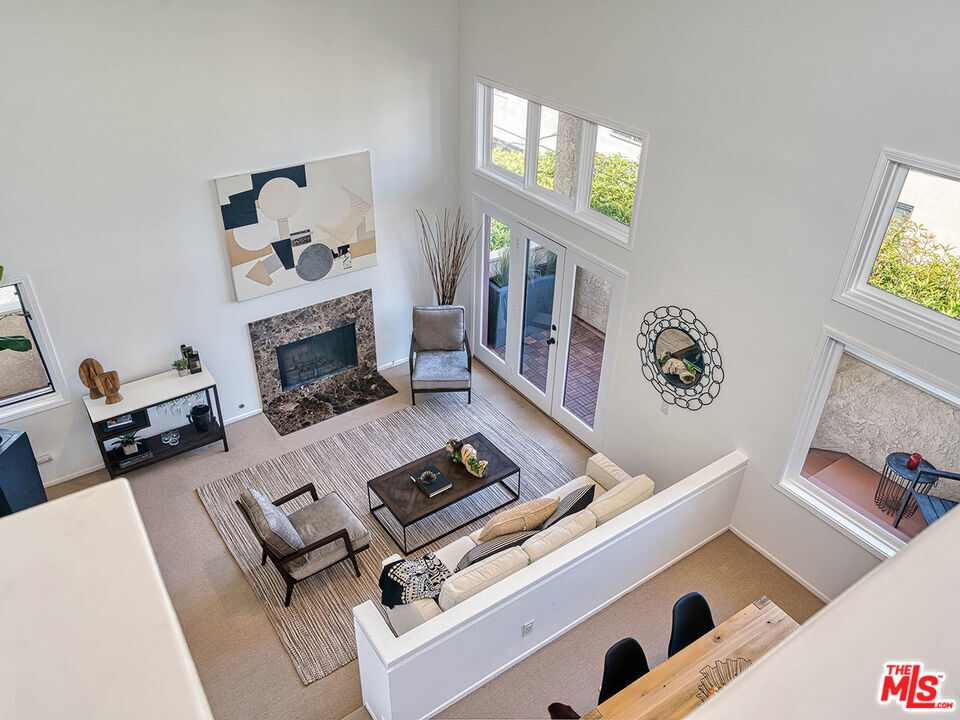 1133 9th Street, Unit 304 Santa Monica, CA 90403 - Photo 21 of 25 a living room with furniture and a fireplace