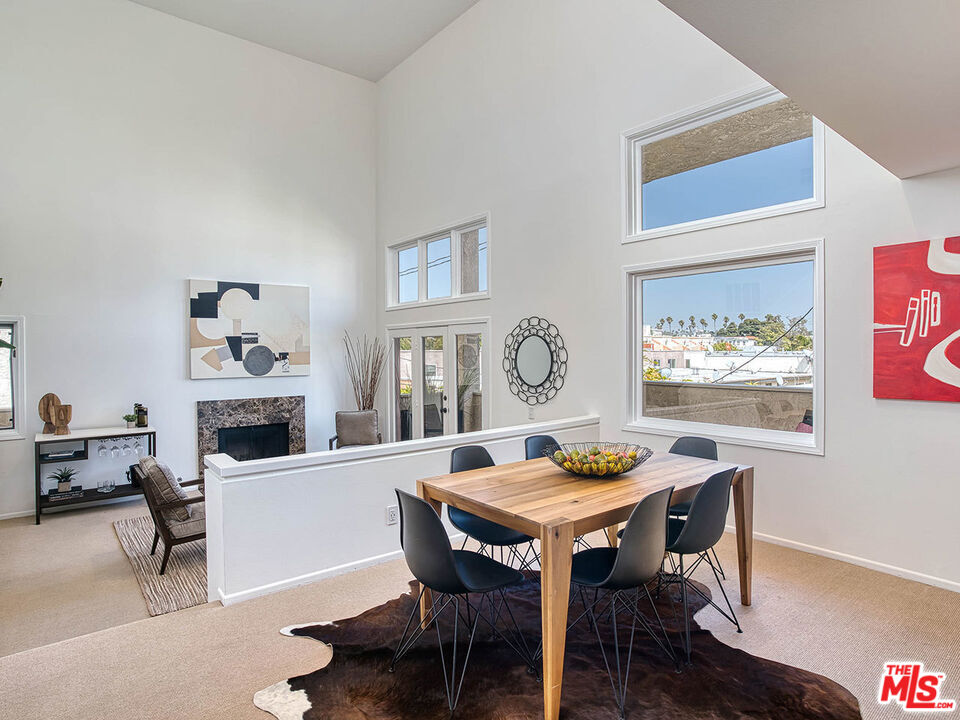 1133 9th Street, Unit 304 Santa Monica, CA 90403 - Photo 3 of 25 a view of a dining room with furniture window and wooden floor