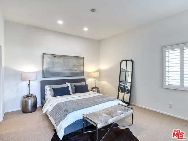 a bedroom with a bed and a lamp