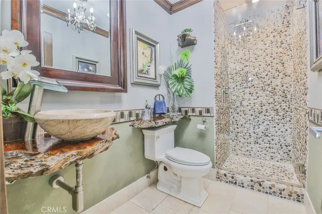 a spacious bathroom with a double vanity sink mirror and shower