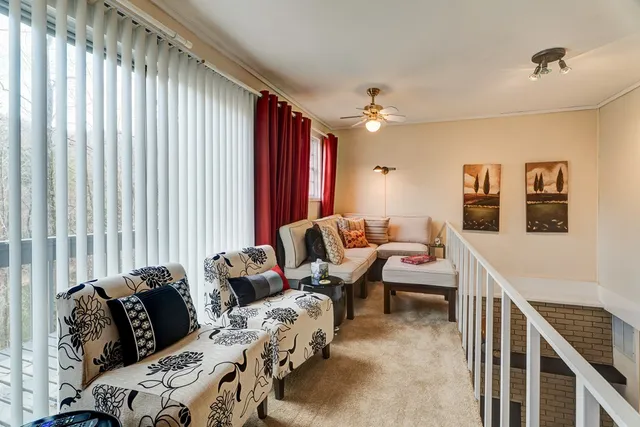 a bedroom with two beds and a large window