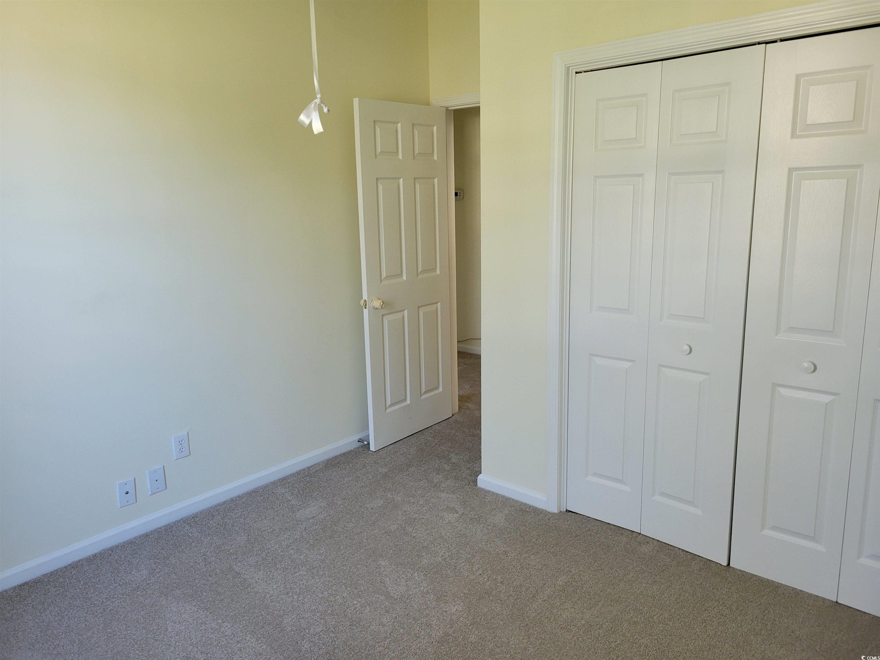 1481 Riceland Court Murrells Inlet, SC 29576 - Photo 15 of 30 Unfurnished bedroom with light carpet and a closet