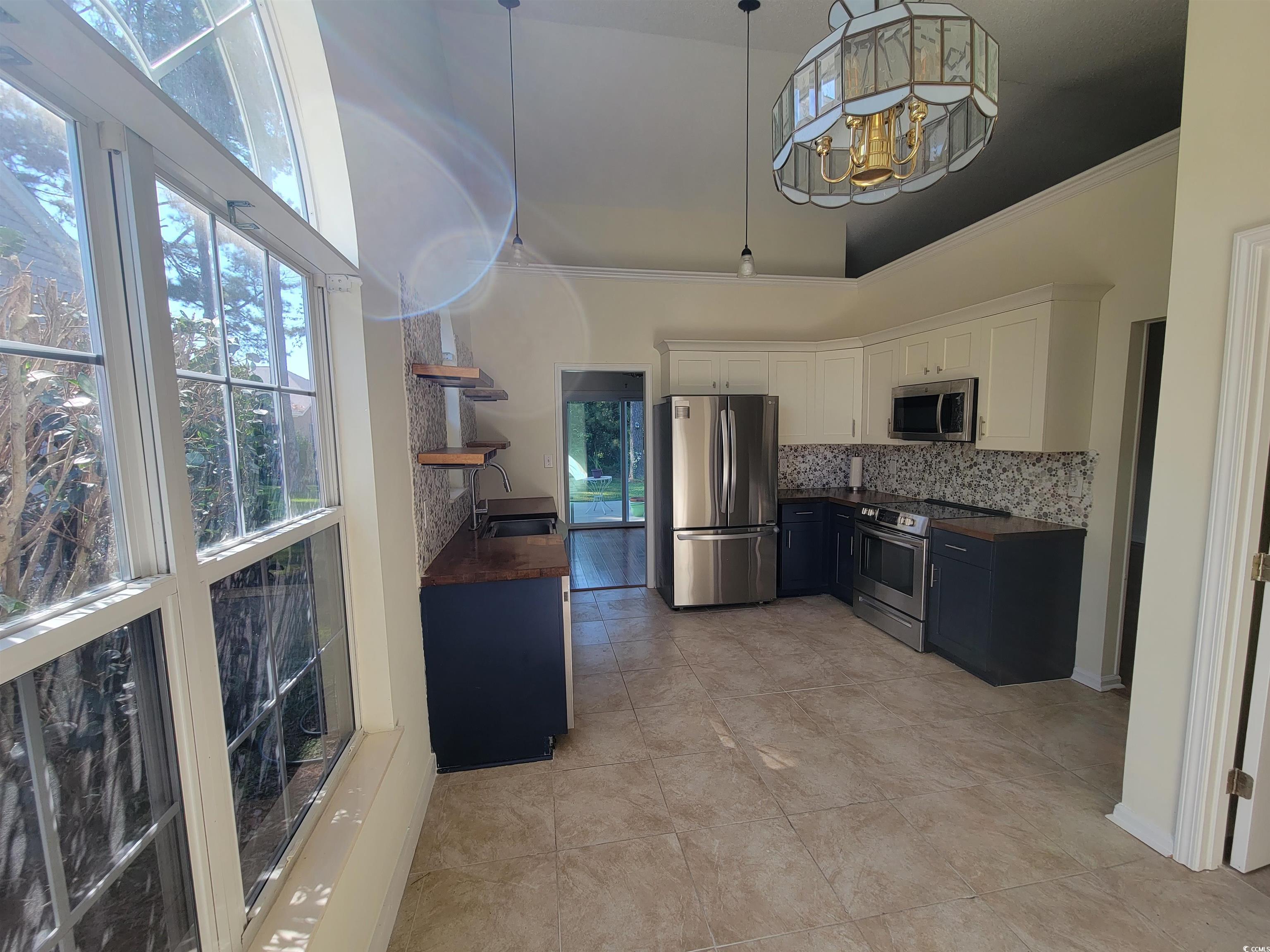 1481 Riceland Court Murrells Inlet, SC 29576 - Photo 23 of 30 Kitchen with butcher block countertops, white cabi