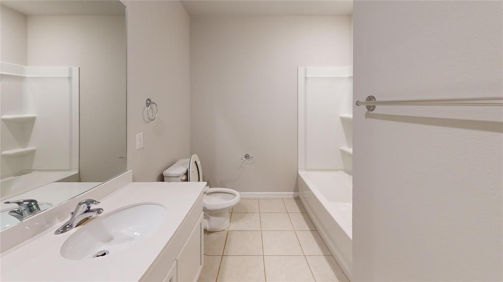 214 Crescent Avenue Melissa, TX 75454 - Photo 15 of 17 a bathroom with a sink a toilet and shower