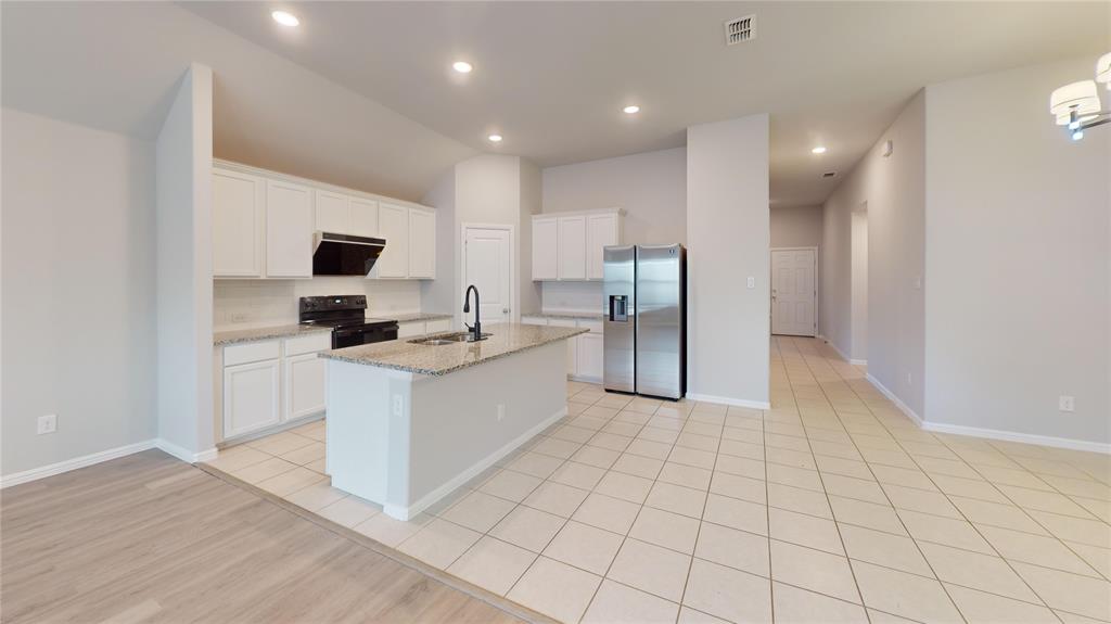 214 Crescent Avenue Melissa, TX 75454 - Photo 4 of 17 a large white kitchen with a stove a sink and a refrigerator