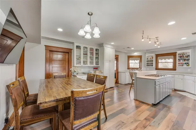 a view of a dining room with furniture and a chandelier