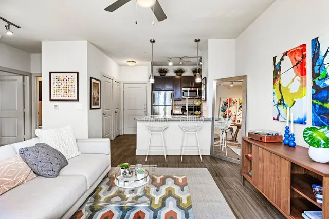 a living room with furniture and wooden floor