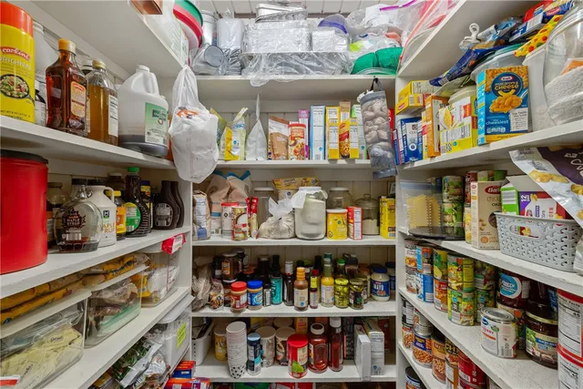 a living room with furniture a chandelier and fireplace