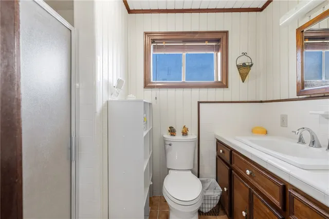 front view of a patio with dining table and chairs with a small yard