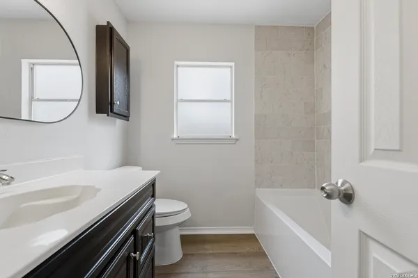a bathroom with a sink a toilet and bathtub