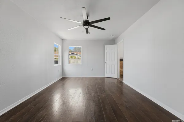 wooden floor in an empty room with a window
