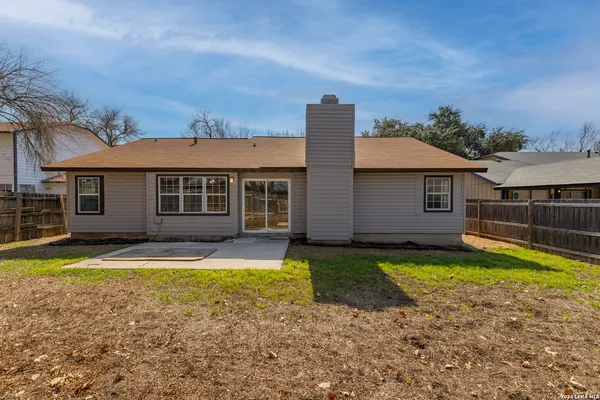 a view of a house with swimming pool and a yard