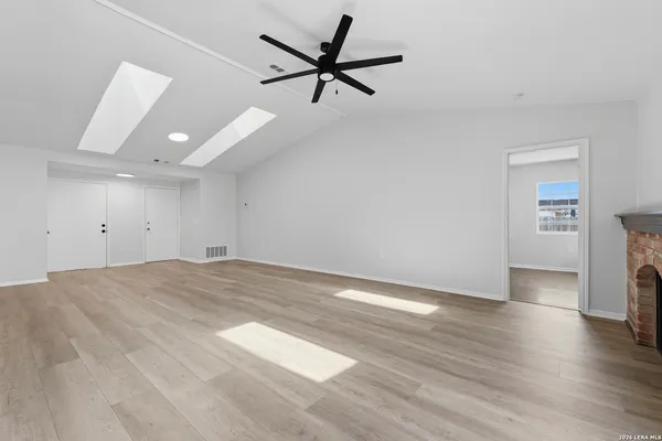 a view of a livingroom with a hardwood floor and a ceiling fan