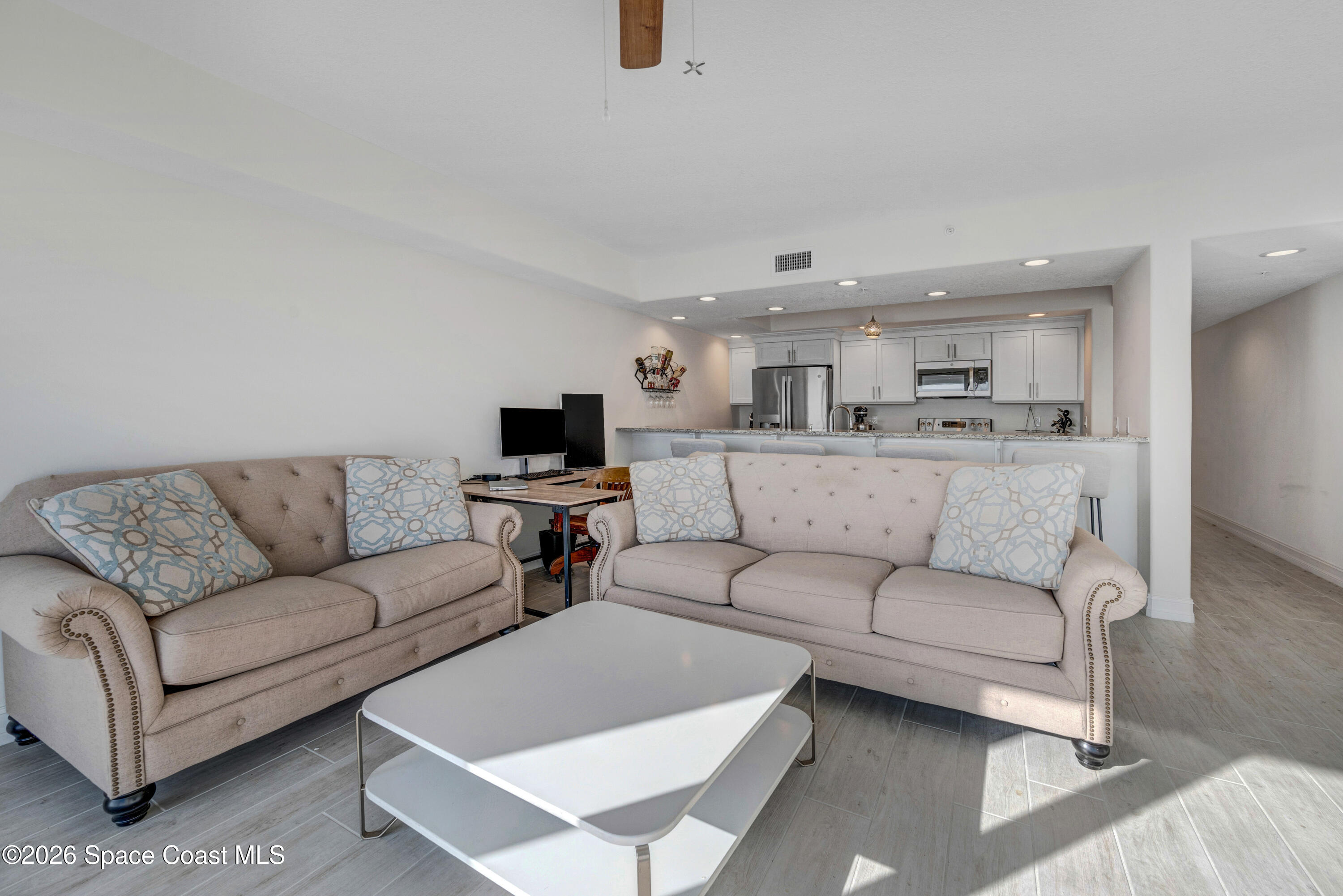 1825 Riverside Drive, Unit 204 Titusville, FL 32780 - Photo 11 of 29 a living room with a couches and kitchen view