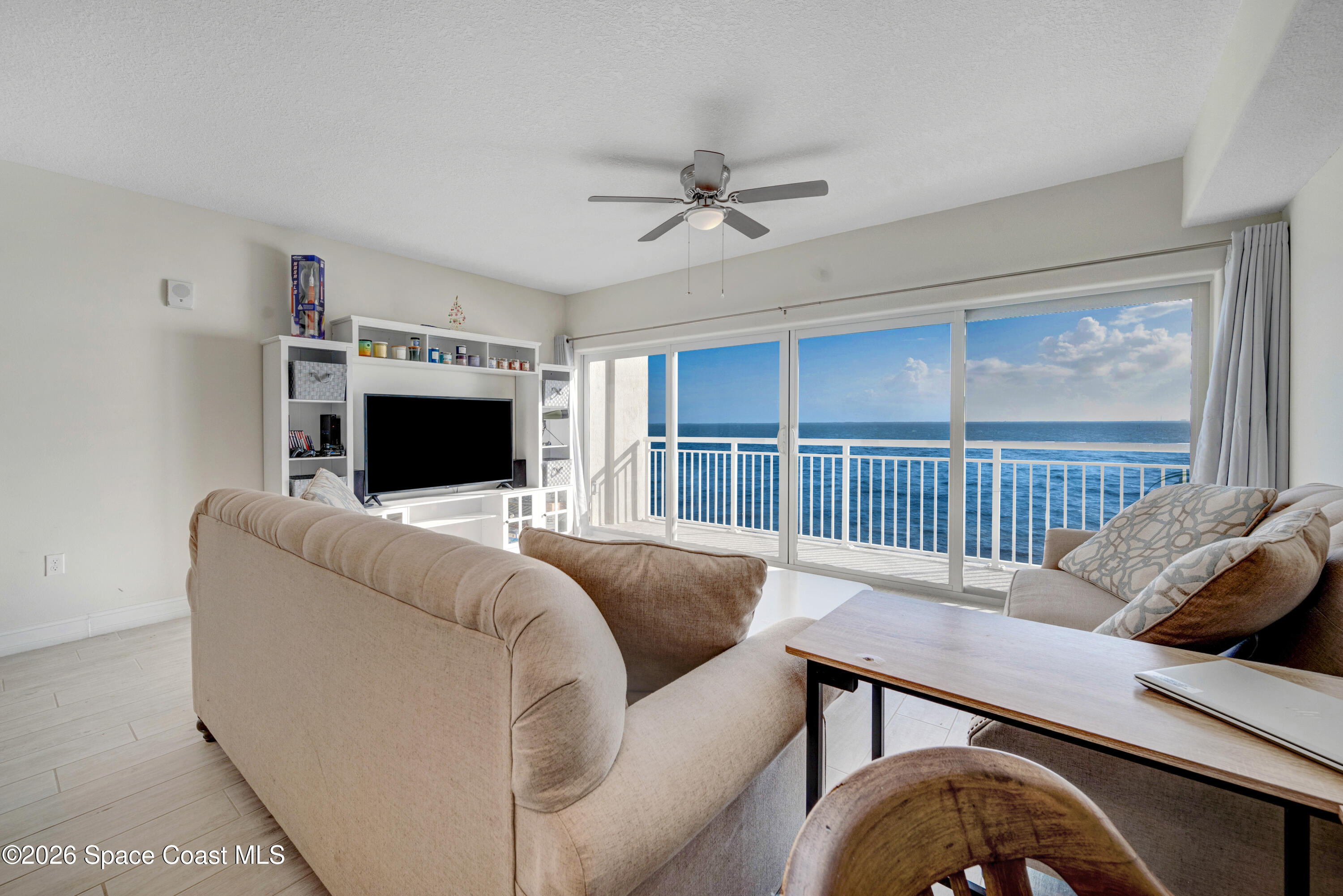 1825 Riverside Drive, Unit 204 Titusville, FL 32780 - Photo 12 of 29 a living room with furniture and a flat screen tv