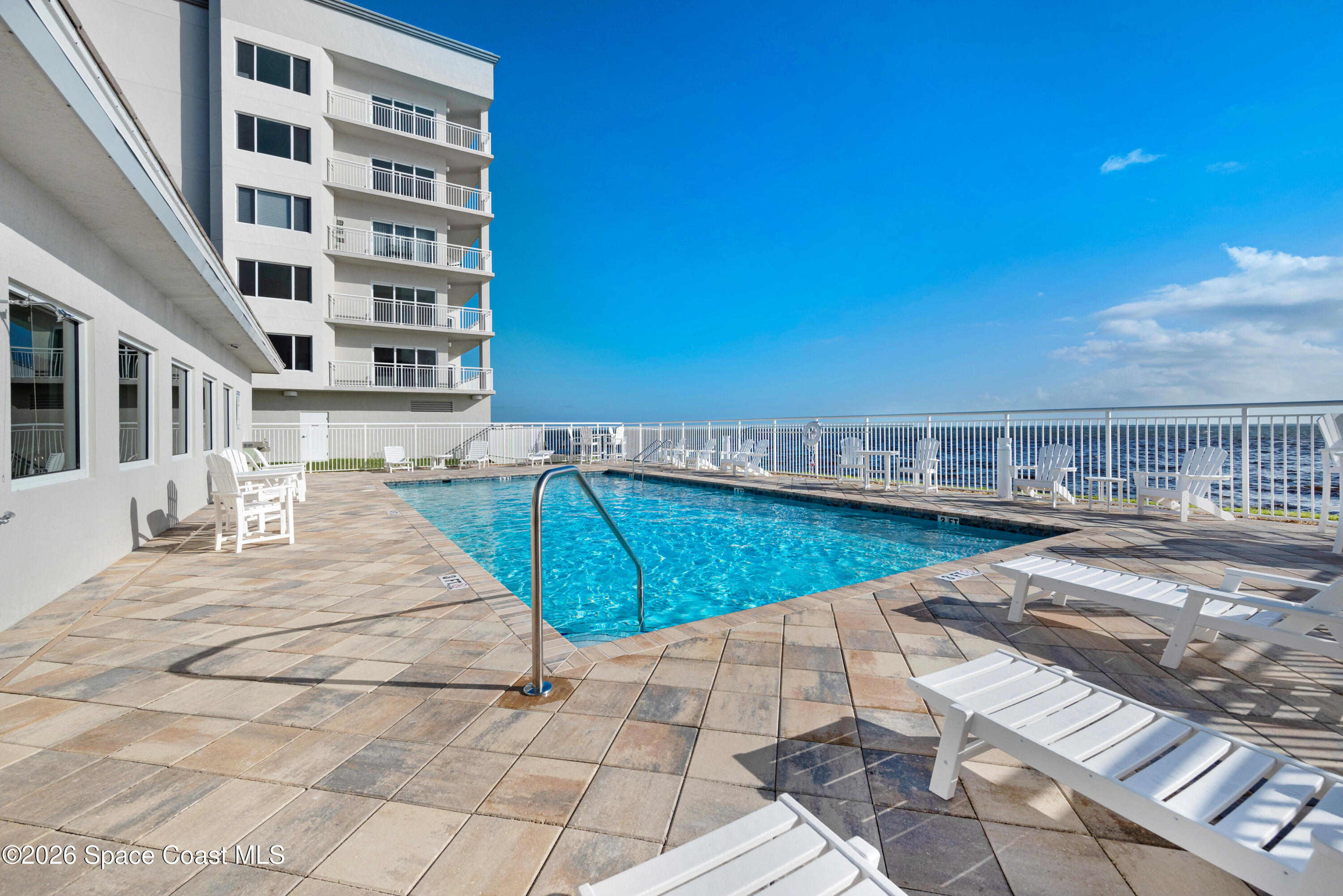 1825 Riverside Drive, Unit 204 Titusville, FL 32780 - Photo 22 of 29 a view of a swimming pool with a lounge chairs