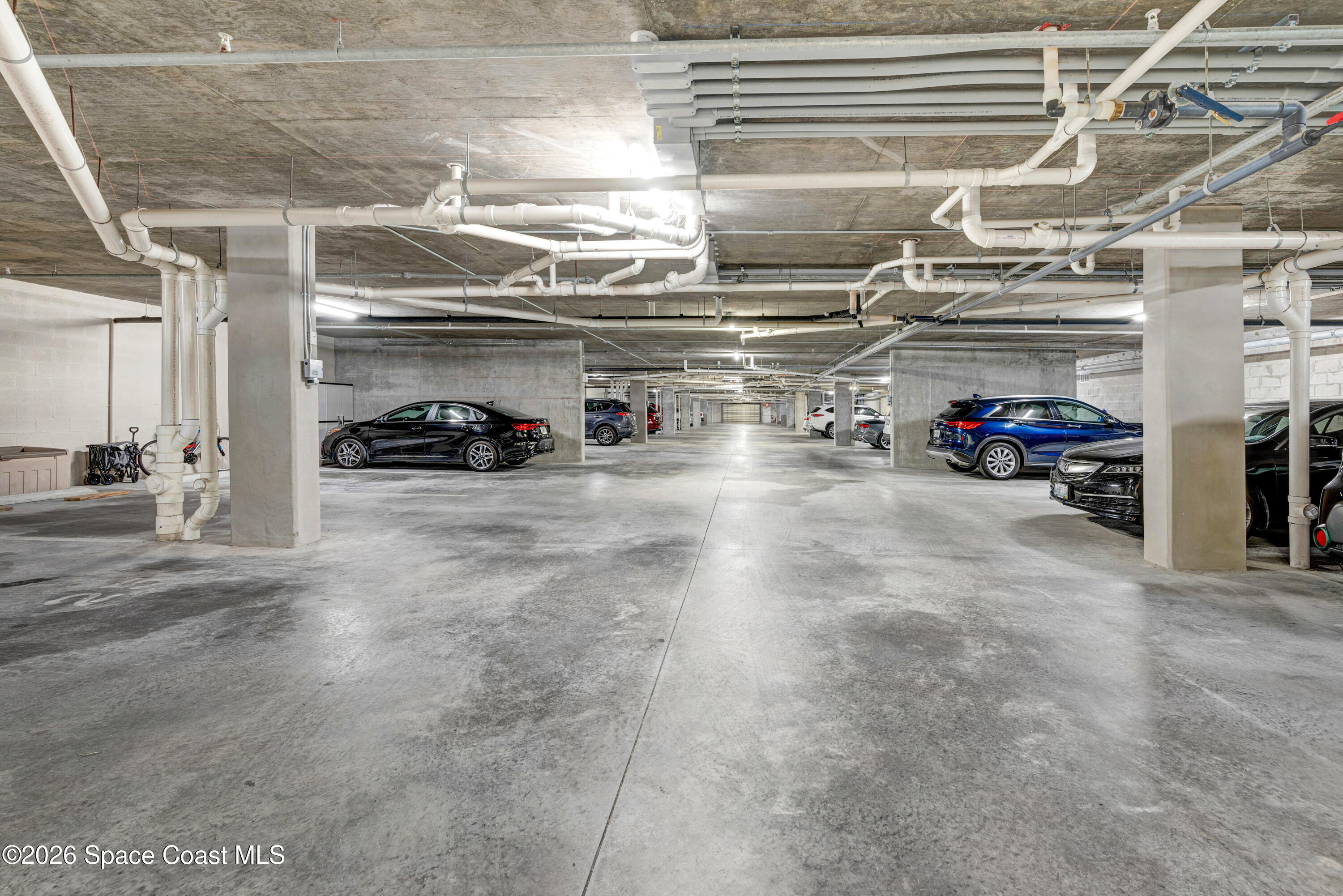 1825 Riverside Drive, Unit 204 Titusville, FL 32780 - Photo 26 of 29 a view of parking garage with cars