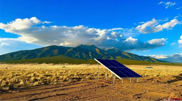 a view of a house with backyard and a garden