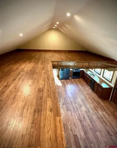 a view of room with wooden floor