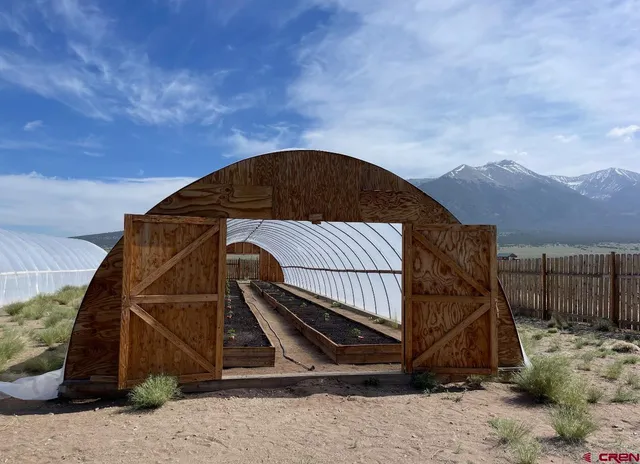 a view of roof and wooden fence
