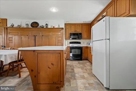 a kitchen that has a stove and a table in it