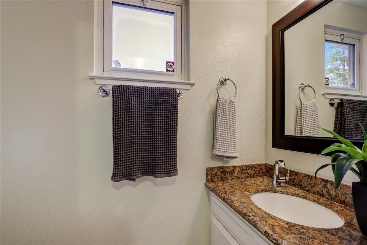 1276 Echo Valley Drive San Jose, CA 95120 - Photo 27 of 54 a bathroom with a granite countertop sink vanity and a mirror