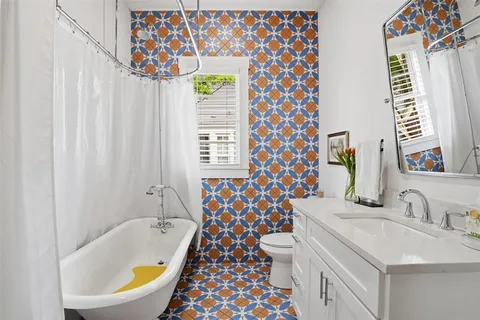 a bathroom with a sink and a blue curtain