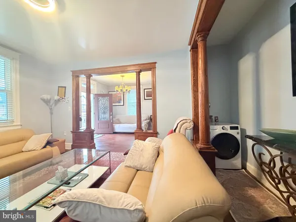a bedroom with furniture and a large window