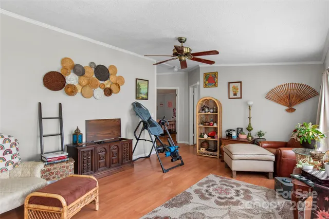 a bedroom with furniture and a fan