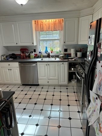 66 Birch Meadow Road Merrimac, MA 01860 - Photo 8 of 19 a kitchen with a sink a stove a window and cabinets