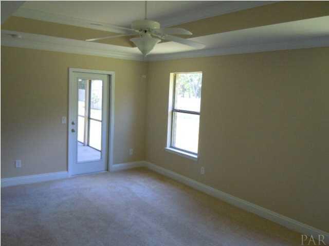 32748 Arbor Ridge Circle Lillian, AL 36549 - Photo 10 of 11 large master bedroom with tray ceiling and door opening to large screened porch.