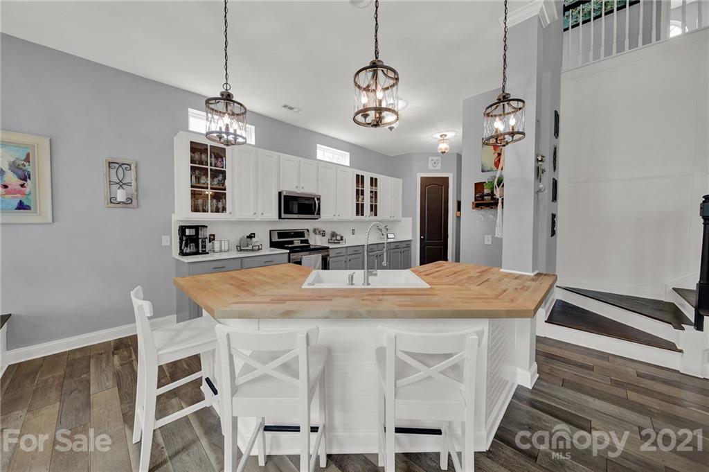 324 Miners Cove Way Fort Mill, SC 29708 - Photo 12 of 48 a view of a dining room with furniture a chandelier and wooden floor