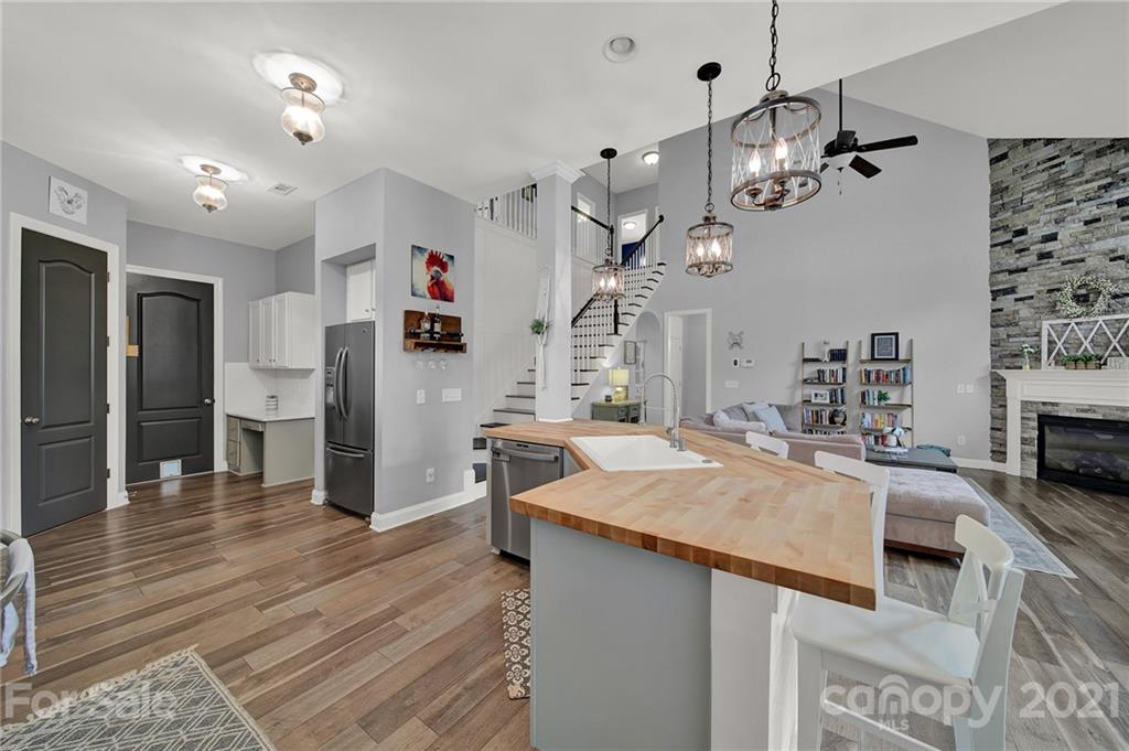 324 Miners Cove Way Fort Mill, SC 29708 - Photo 13 of 48 a kitchen with stainless steel appliances kitchen island granite countertop a refrigerator a oven a sink and a refrigerator