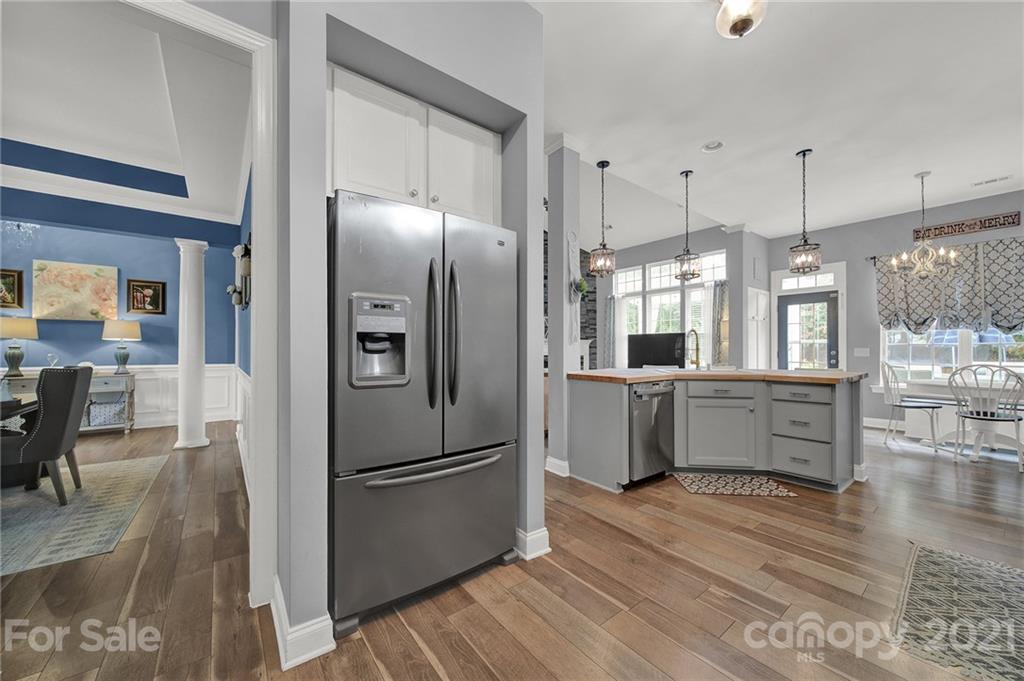324 Miners Cove Way Fort Mill, SC 29708 - Photo 16 of 48 a kitchen with stainless steel appliances a refrigerator sink and wooden floor