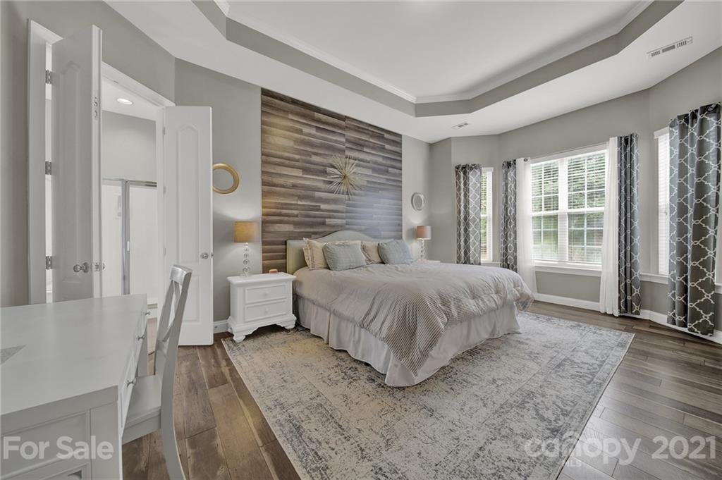 324 Miners Cove Way Fort Mill, SC 29708 - Photo 19 of 48 a spacious bedroom with a bed and large windows