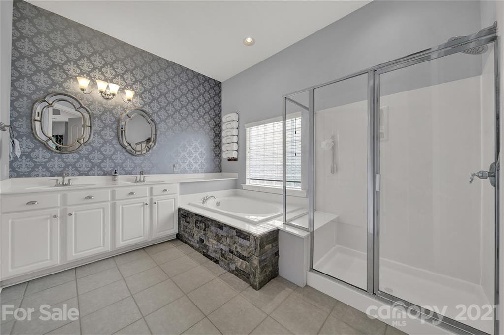 324 Miners Cove Way Fort Mill, SC 29708 - Photo 22 of 48 a spacious bathroom with a double vanity sink mirror and